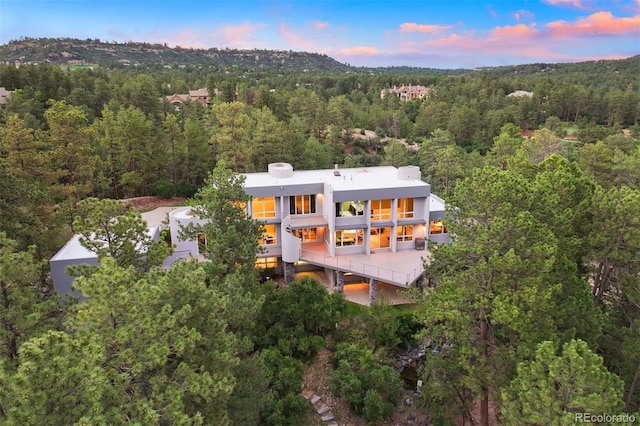 birds eye view of property with a forest view