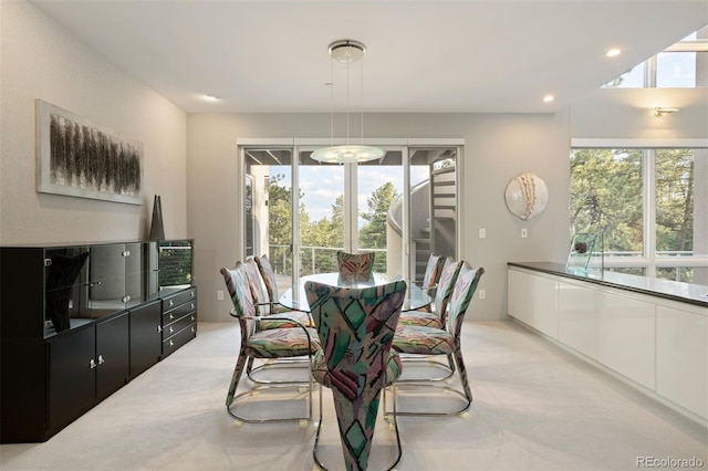 dining room with recessed lighting, stairway, and light colored carpet