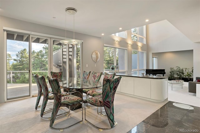 dining space with recessed lighting and a high ceiling