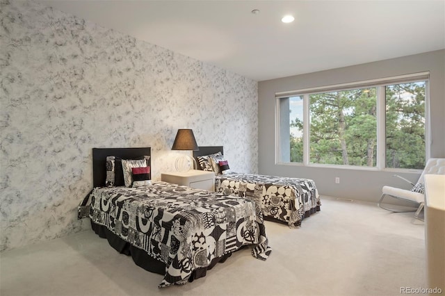 carpeted bedroom with wallpapered walls and recessed lighting