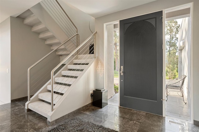 entrance foyer featuring stairs and visible vents