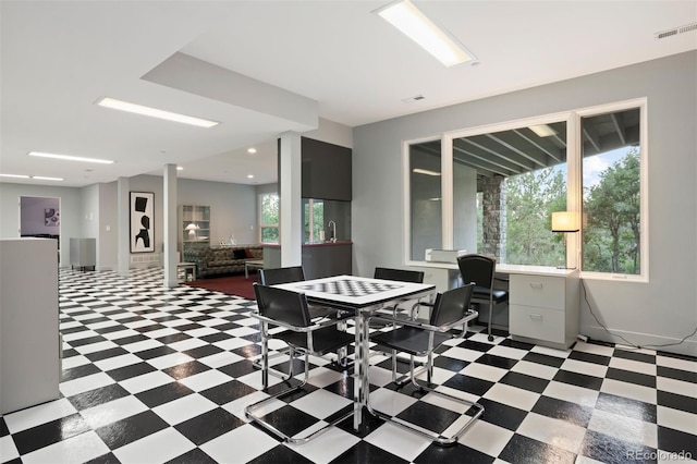 recreation room featuring light floors, visible vents, and baseboards