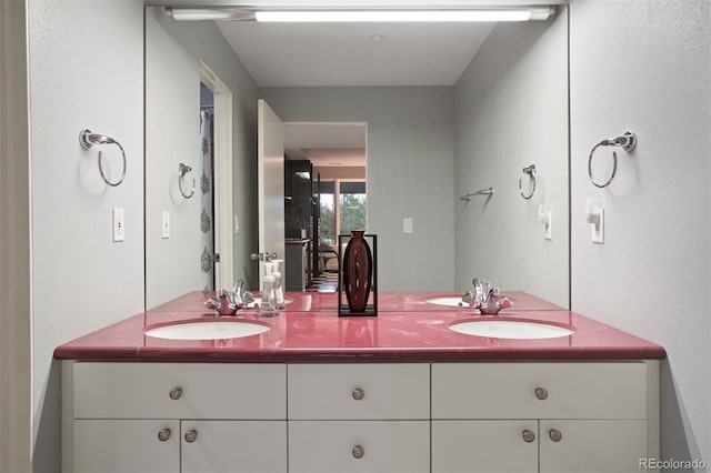 bathroom featuring double vanity and a sink