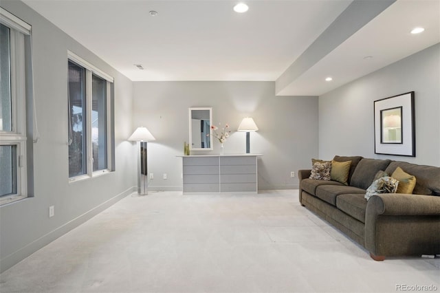 living room with recessed lighting, light colored carpet, and baseboards