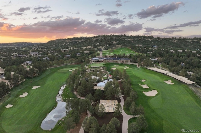 aerial view at dusk featuring golf course view