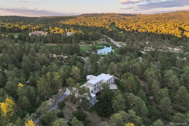 aerial view at dusk with a view of trees