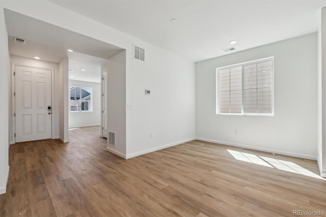 unfurnished room with visible vents and light wood-style floors