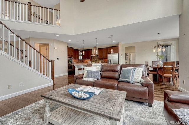 10365 Prairie Sky Pl, Lone Tree, CO 80124 - living room featuring wood finished floors, a chandelier, stairway, and recessed lighting