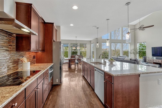 10365 Prairie Sky Pl, Lone Tree, CO 80124 - kitchen featuring wall chimney exhaust hood, stainless steel appliances, dark wood finished floors, open floor plan, and ceiling fan