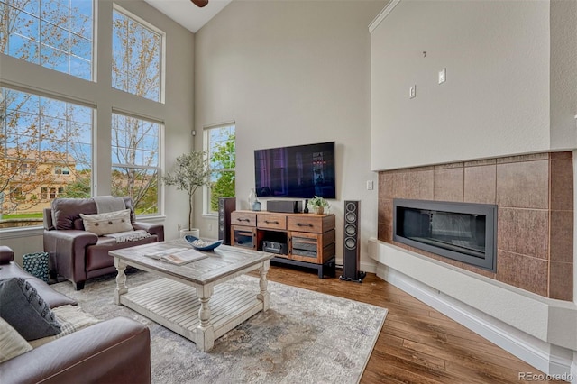10365 Prairie Sky Pl, Lone Tree, CO 80124 - living area with high vaulted ceiling, wood finished floors, and a tile fireplace