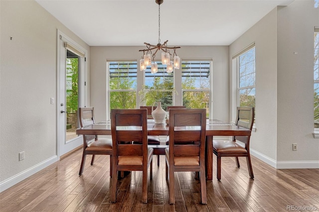 10365 Prairie Sky Pl, Lone Tree, CO 80124 - dining space featuring plenty of natural light, wood finished floors, a chandelier, and a textured wall