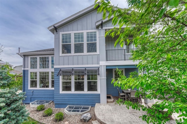 10365 Prairie Sky Pl, Lone Tree, CO 80124 - back of house featuring a balcony, board and batten siding, and a patio