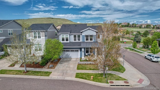 10365 Prairie Sky Pl, Lone Tree, CO 80124 - view of front of home with driveway, a residential view, an attached garage, and board and batten siding