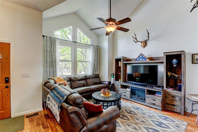 8555 Angela Ln, Parker, CO 80134 - living room with ceiling fan, wood finished floors, baseboards, and high vaulted ceiling