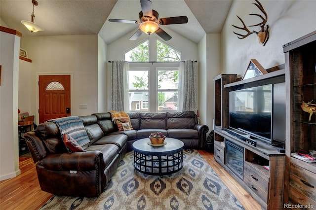 8555 Angela Ln, Parker, CO 80134 - living room featuring vaulted ceiling, light wood finished floors, and a ceiling fan