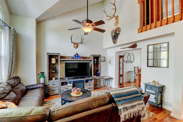 8555 Angela Ln, Parker, CO 80134 - living room with a ceiling fan, wood finished floors, high vaulted ceiling, baseboards, and radiator heating unit