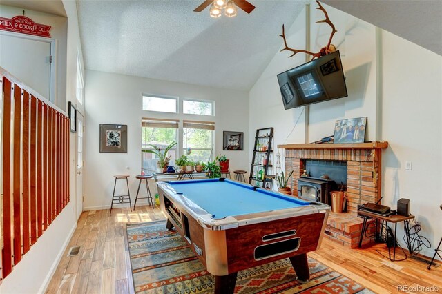 8555 Angela Ln, Parker, CO 80134 - playroom featuring pool table, high vaulted ceiling, light wood finished floors, ceiling fan, and a wood stove