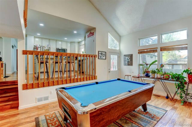 8555 Angela Ln, Parker, CO 80134 - rec room with light wood-style flooring, billiards table, high vaulted ceiling, baseboards, and a textured ceiling