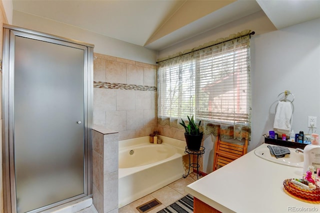 8555 Angela Ln, Parker, CO 80134 - full bath with tile patterned floors, a shower stall, a garden tub, vaulted ceiling, and vanity