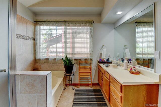 8555 Angela Ln, Parker, CO 80134 - bathroom featuring a garden tub, vanity, and tile patterned flooring