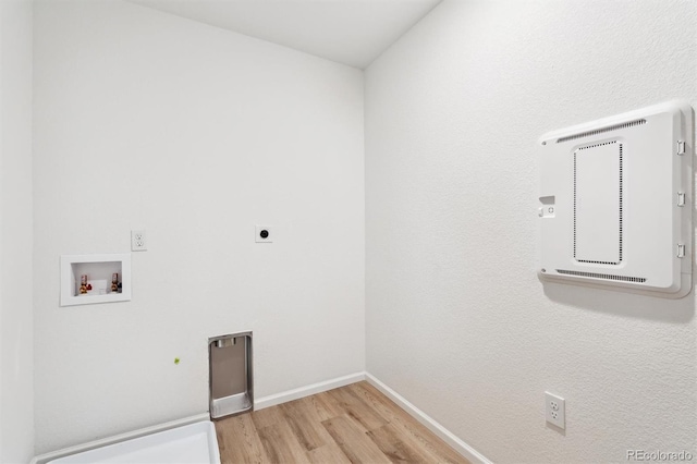 laundry area featuring baseboards, light wood-type flooring, washer hookup, laundry area, and hookup for an electric dryer