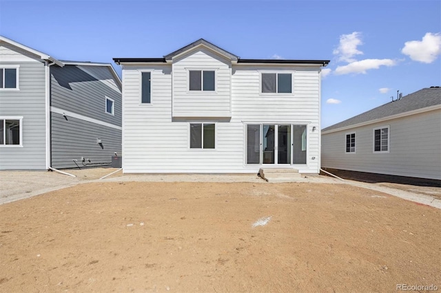 back of property featuring entry steps