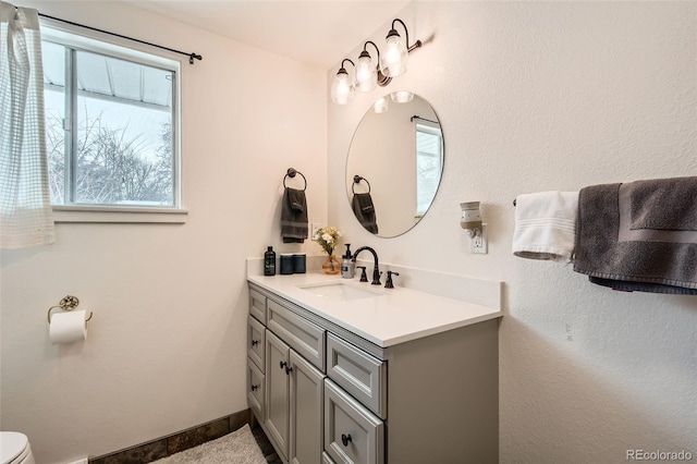 bathroom with vanity and toilet