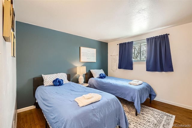 bedroom with dark hardwood / wood-style floors