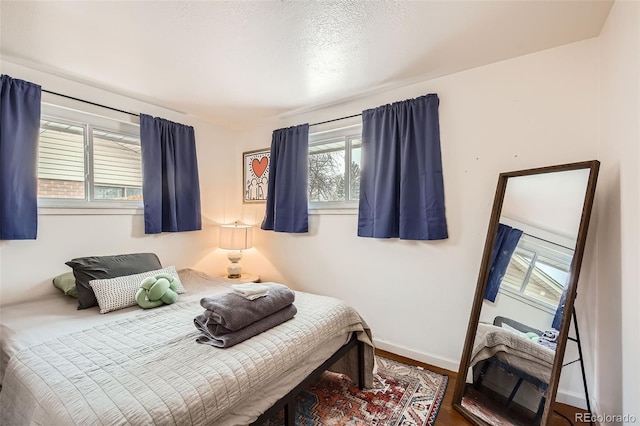 bedroom with hardwood / wood-style floors