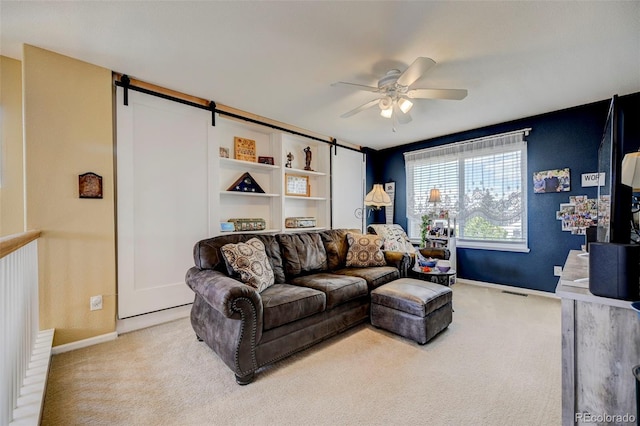 9172 Sunningdale Rd, Peyton, CO 80831 - living area with baseboards, a barn door, and light carpet