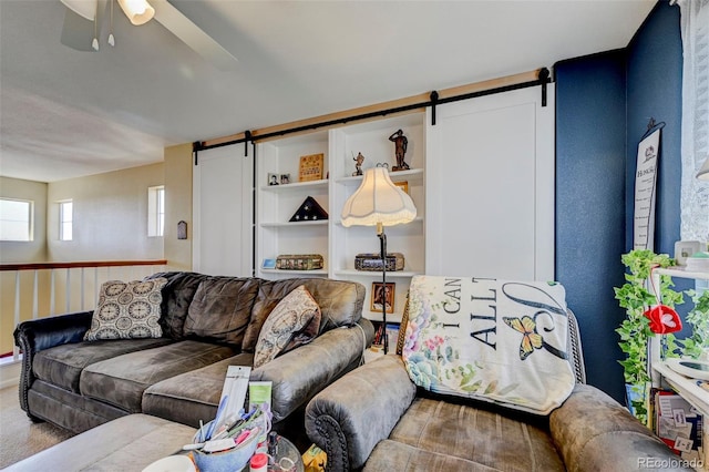 9172 Sunningdale Rd, Peyton, CO 80831 - carpeted living area with ceiling fan and a barn door