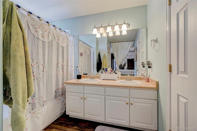 9172 Sunningdale Rd, Peyton, CO 80831 - full bath with a sink, curtained shower, double vanity, and wood finished floors