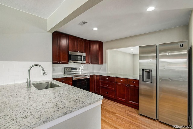 3092 S Kearney St, Denver, CO 80222 - kitchen featuring stainless steel appliances, a sink, dark brown cabinets, light stone countertops, and recessed lighting