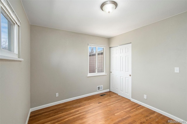 3092 S Kearney St, Denver, CO 80222 - unfurnished bedroom featuring baseboards, light wood-type flooring, and a closet