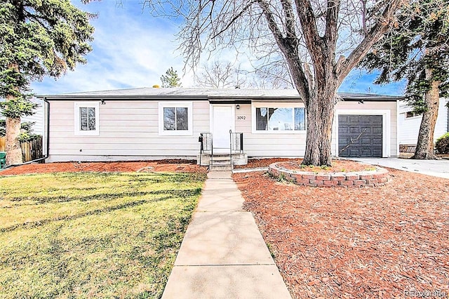 ranch-style home featuring a garage and a front yard