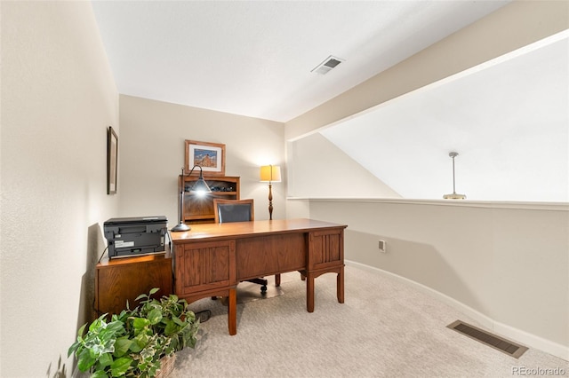 carpeted office space featuring vaulted ceiling with beams