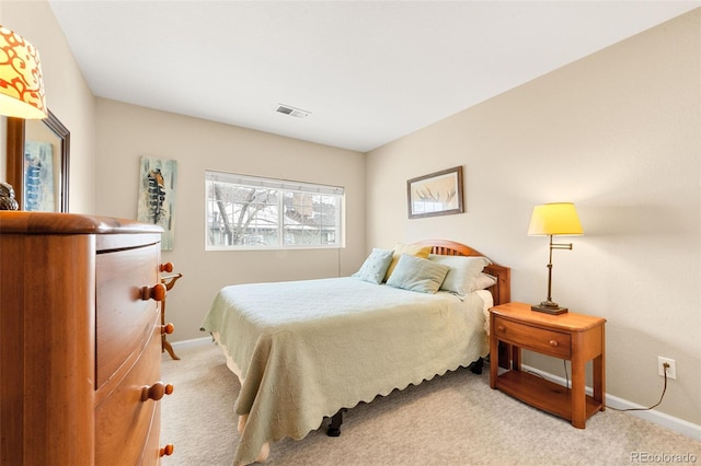 bedroom featuring light carpet