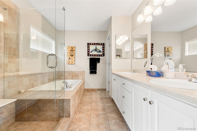 bathroom with tile patterned flooring, vanity, separate shower and tub, and a wealth of natural light