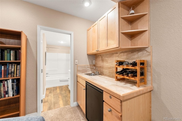 kitchen featuring sink, tasteful backsplash, light colored carpet, fridge, and light brown cabinetry