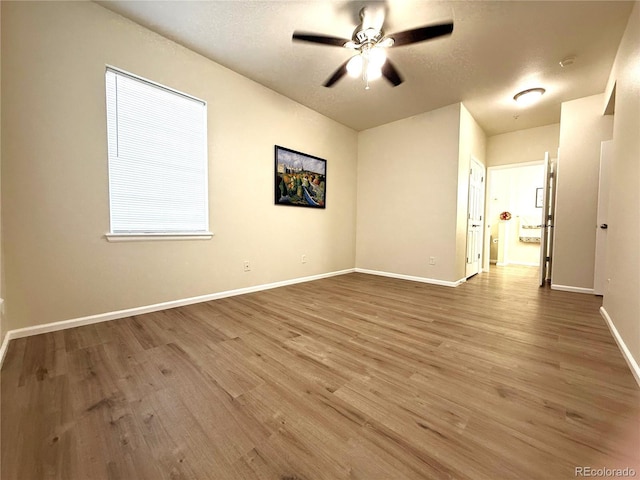 4451 S Ammons St Unit 108, Littleton, CO 80123 - empty room featuring wood finished floors, a ceiling fan, and a textured ceiling