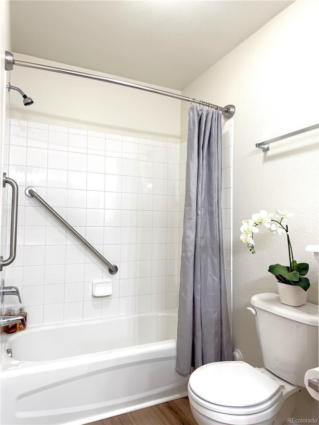 4451 S Ammons St Unit 108, Littleton, CO 80123 - full bath featuring shower / bath combo with shower curtain and wood finished floors