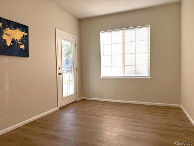 4451 S Ammons St Unit 108, Littleton, CO 80123 - unfurnished room with wood finished floors and baseboards