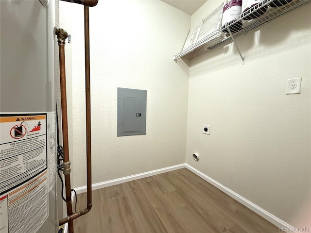 4451 S Ammons St Unit 108, Littleton, CO 80123 - laundry area featuring water heater, electric panel, hookup for an electric dryer, and wood finished floors