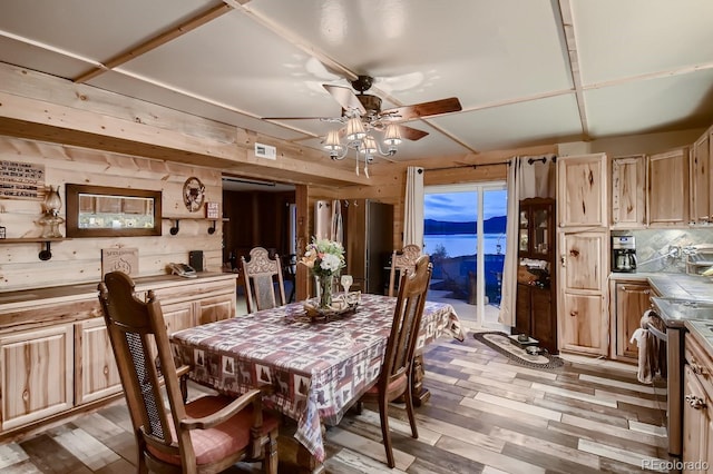 dining room with wooden walls, light hardwood / wood-style floors, and ceiling fan