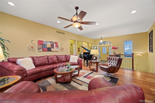 living room featuring a ceiling fan, recessed lighting, wood finished floors, and visible vents