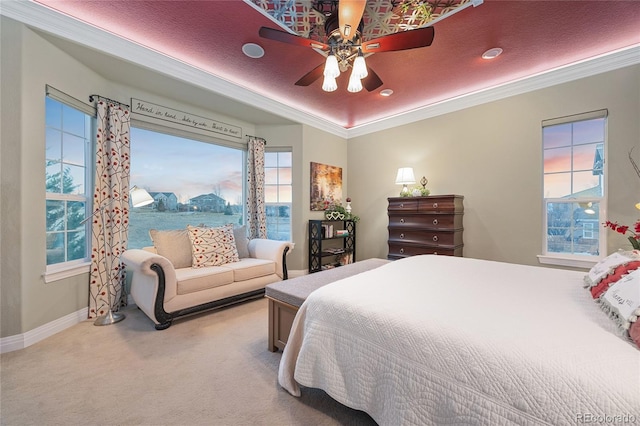 bedroom featuring a ceiling fan, crown molding, carpet, and baseboards