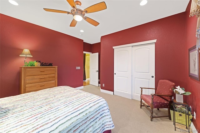 carpeted bedroom with recessed lighting, a closet, baseboards, and a ceiling fan