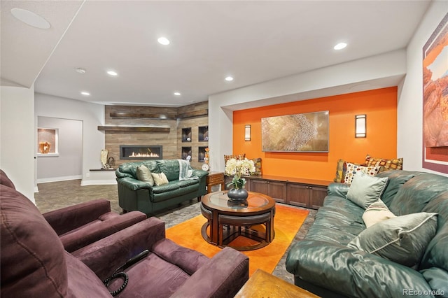 living room featuring a fireplace, recessed lighting, and baseboards