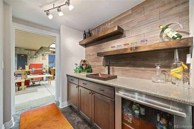 bar with wine cooler and a sink