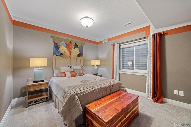 carpeted bedroom with visible vents and baseboards